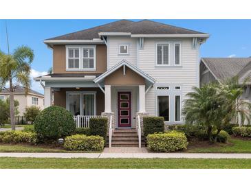 Charming two-story home boasts manicured landscaping and a vibrant entryway at 13831 Briand Ave, Orlando, FL 32827