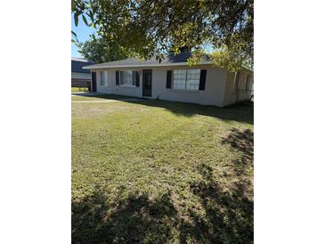 Well maintained home featuring a green lawn, neutral paint, and a cozy appeal at 414 Dakota Ave, St Cloud, FL 34769