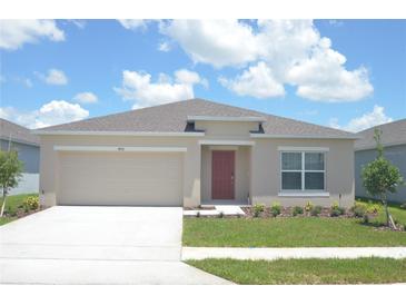 Charming single-story home with manicured lawn and neutral-colored exterior at 4881 Vellacito Way, Davenport, FL 33897