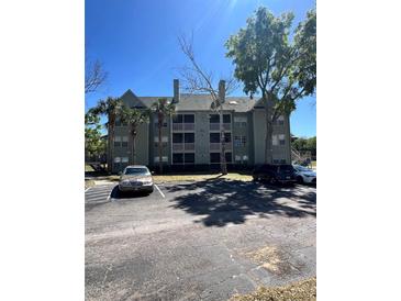Well-maintained condo building featuring multiple stories, balconies, and convenient parking at 6148 Westgate Dr # 302, Orlando, FL 32835
