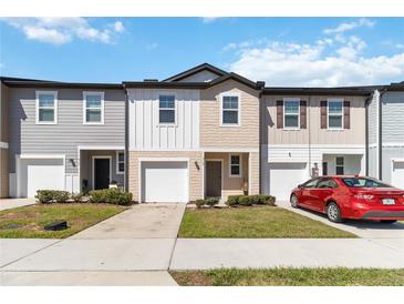 Charming townhomes with individual garages and a manicured lawn at 916 Grandin St, Davenport, FL 33837