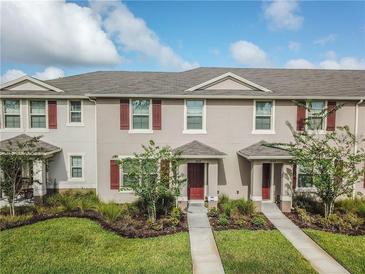 Charming townhome with manicured lawn and decorative shutters at 1459 Rylee Rock Way, Kissimmee, FL 34744