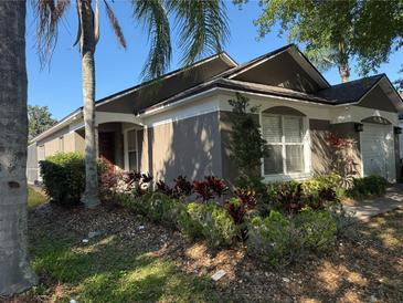 Charming single-story home with a well-maintained lawn, mature landscaping, and inviting entrance at 2917 Kokomo Loop, Haines City, FL 33844