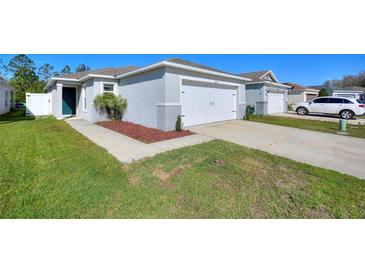 Charming single-story home with a well-maintained lawn, a two-car garage, and a cozy front entrance at 4677 Glencrest Loop, St Cloud, FL 34772
