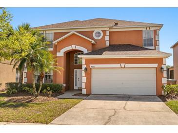 Charming two-story home with a well-manicured lawn and an attached two-car garage at 4692 Sw Golden Beach N Ct, Kissimmee, FL 34746