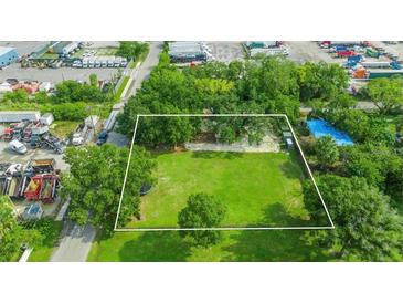 Expansive aerial view showcasing a lush green lot with mature trees and a defined boundary line at 512 Palmetto St, Orlando, FL 32824