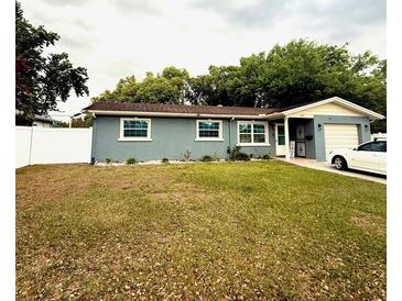 Charming single-story home featuring a well-maintained lawn, and a single car garage at 6337 Lido Ct, Orlando, FL 32807