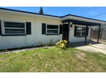 Charming single-story home featuring a well-kept lawn, black shutters, and a welcoming entryway at 1539 Roselawn Sw St, Winter Haven, FL 33880