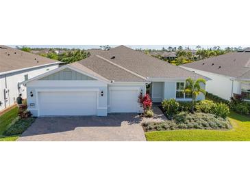 Charming single-story home featuring a brick driveway, two-car garage and meticulously landscaped front yard at 2719 River Creek Ln, St Cloud, FL 34771