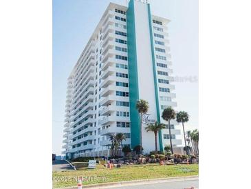Spacious condo tower featuring multiple balconies with lovely tropical landscaping at 2800 N Atlantic Ave # 1411, Daytona Beach, FL 32118