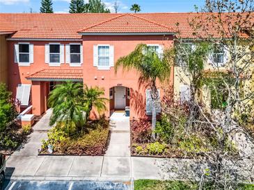 Charming townhouse featuring a red tile roof and well-maintained landscaping at 4743 Vero Beach Pl, Kissimmee, FL 34746