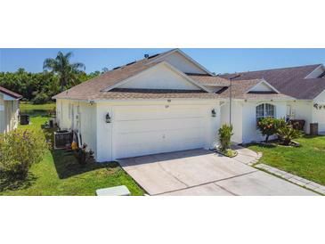 Charming single-story home with a two-car garage, well-maintained lawn and landscaping at 529 Eagle Pointe N, Kissimmee, FL 34746