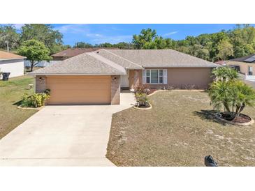 Charming one-story home with a well-maintained lawn and a two-car garage at 6056 Hillside Heights Dr, Lakeland, FL 33812