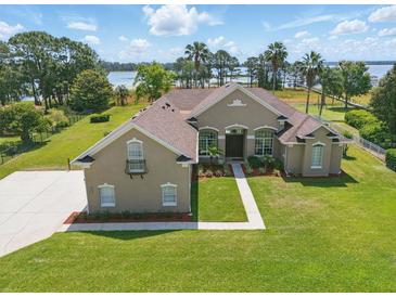Beautiful home with lush lawn, nice landscaping, and lovely lake views from almost every angle at 6132 Waterfield Way, St Cloud, FL 34771