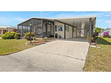 Charming home featuring a screened-in porch and a covered carport at 6711 Canterbury Ne Dr, Winter Haven, FL 33881