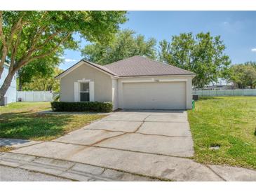 Charming single-story home with a well-maintained lawn and attached two-car garage at 7316 Hunters Greene Cir, Lakeland, FL 33810