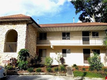 Two story condo building featuring stucco and stone exterior with well maintained landscaping at 845 Orchid Springs Dr, Winter Haven, FL 33884