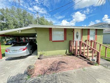 Charming single-story home with a covered parking area and brick front porch at 2406 Thelma Ave, Haines City, FL 33844