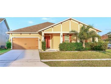 Charming single-story home with a manicured lawn and a attached two-car garage at 3131 Bass Boat Way, Kissimmee, FL 34746