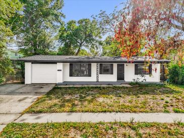 Charming single-story home featuring a well-maintained yard and an attached one-car garage at 4410 Rossmore Dr, Orlando, FL 32810
