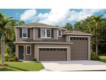 Two-story home featuring a neutral color scheme, a two car garage, and neat landscaping at 1015 Wisteria Way, Dundee, FL 33838