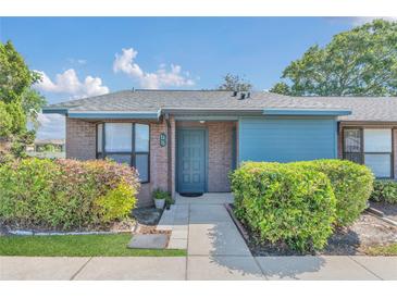 Charming single-story home with brick facade, well-maintained landscaping, and a welcoming blue front door at 2435 King Oak Ln, St Cloud, FL 34769