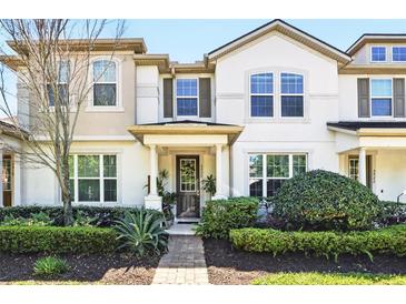 Charming two-story townhome with a well-manicured front yard and inviting entrance at 2920 Windmill Dr, Kissimmee, FL 34741