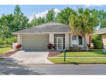 Charming single-story home featuring a well-maintained lawn and a two-car garage at 2958 Sunset Vista Blvd, Kissimmee, FL 34747