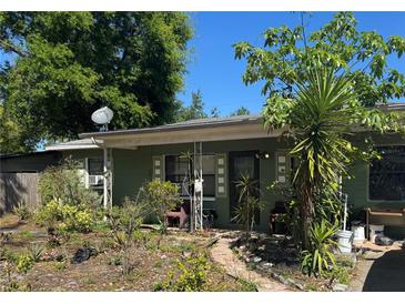 Quaint one story home exterior features well-foliaged landscaping and a covered front porch at 722 Belair Ave, Lakeland, FL 33801