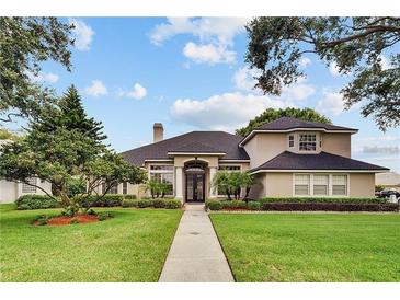 Charming single-story home with well-manicured landscaping and a welcoming entrance at 3637 Rothbury Dr, Belle Isle, FL 32812