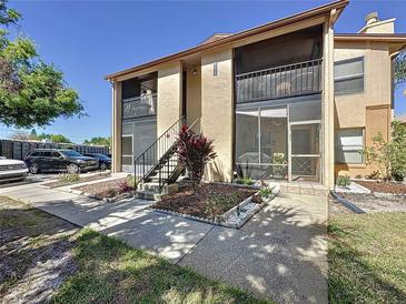 Charming two-story condo featuring dual screened in patios with garden bed and sidewalk entrance at 4858 S Semoran Blvd # 2108, Orlando, FL 32822