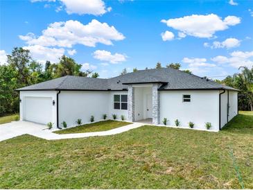 Beautifully landscaped, single-story home featuring a two-car garage and modern gray stone accents at 780 Kangaroo Ct, Deltona, FL 32738