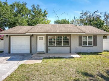 Charming single-Gathering home with a well-maintained lawn, attached garage, and inviting front entrance at 11125 Finchley Pl, Orlando, FL 32837