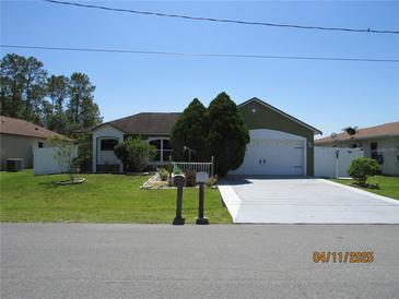 Charming single-story home with a well-maintained lawn, long driveway and a two car garage at 1155 Roan Ct, Kissimmee, FL 34759
