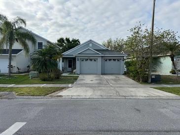 Charming single-story home with a two-car garage and well-maintained landscaping at 2406 Knightsbridge Blvd, Kissimmee, FL 34744