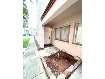 Condo exterior featuring a well-maintained front yard and a welcoming entrance at 2538 Citrus Club Ln # 105, Orlando, FL 32839
