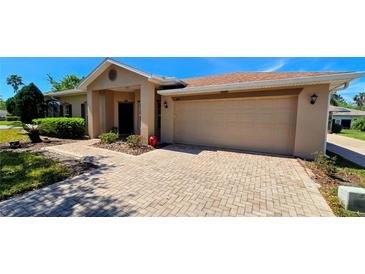 Charming single-story home with a well-maintained lawn and a spacious two-car garage at 300 Falling Water Dr, Kissimmee, FL 34759