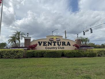 The Ventura Country Club entrance sign is framed by lush landscaping and palm trees, welcoming residents and guests at 3592 Southpointe Dr # 2, Orlando, FL 32822