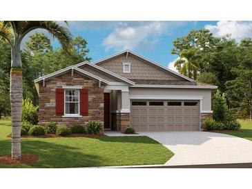 Charming single-Gathering home with stone accents, attached two-car garage, and well-manicured front lawn at 4075 Bannock Ave, Tavares, FL 32778