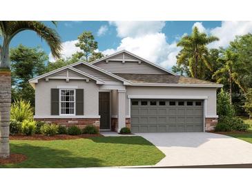 Charming single-Gathering home featuring a two-car garage, stone accents, and lush landscaping at 4079 Bannock Ave, Tavares, FL 32778