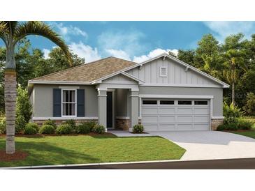 Charming single-story home featuring a two-car garage, landscaped yard and modern architectural details at 4083 Bannock Ave, Tavares, FL 32778