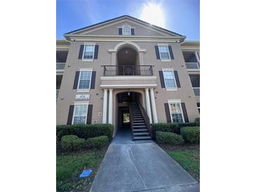 Attractive three-story condo building with well-manicured landscaping and elegant architectural details at 14341 Fredricksburg Dr # 1016, Orlando, FL 32837