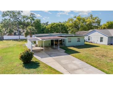 Single story house with carport and well-maintained front yard with green grass at 224 Pennsylvania Ave, St Cloud, FL 34769