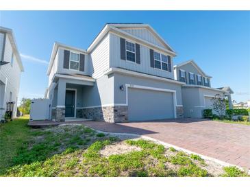 Charming two-story home featuring a two-car garage and stone accents at 3173 Armstrong Spring Dr, Kissimmee, FL 34744