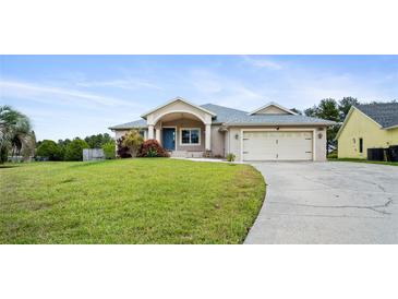 Charming single-story home with a well-manicured lawn, two-car garage, and a welcoming front porch at 5524 Loma Vista, Davenport, FL 33896