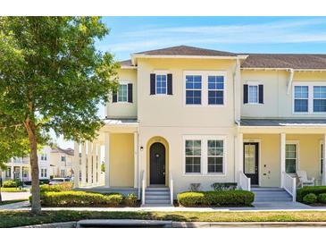 Charming two-story townhouse featuring a well-maintained front yard and inviting facade at 1370 Kiawah St, Celebration, FL 34747