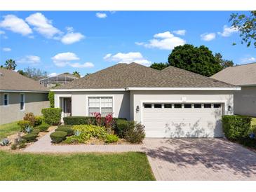 Charming single Gathering home featuring a well maintained lawn and a two car garage at 1821 N Hampton Dr, Davenport, FL 33897