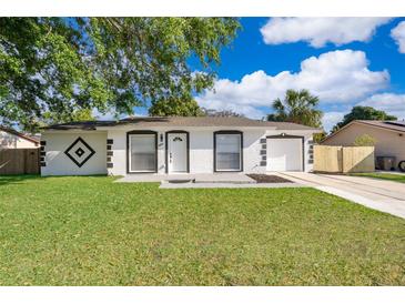 Charming single-story home featuring a well-manicured lawn and a freshly painted exterior at 201 La Paz Dr, Kissimmee, FL 34743