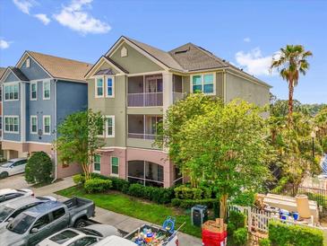 Multi-story condominium featuring private screened balconies and a well-maintained lawn at 3344 Corona Village Way # 308, Orlando, FL 32835