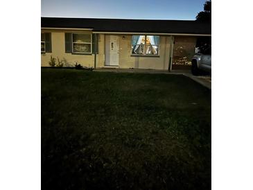 Cozy single-story home with dark shutters and a well-maintained lawn at 4343 Lake Richmond Dr, Orlando, FL 32811